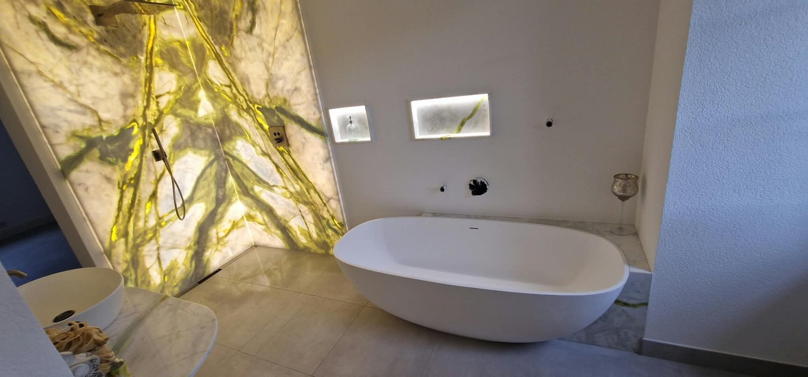 Badewanne und beleuchtete Wand während der Fertigstellung